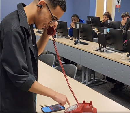 MGA student uses a rotary phone at the MoT Rotary Revival event.